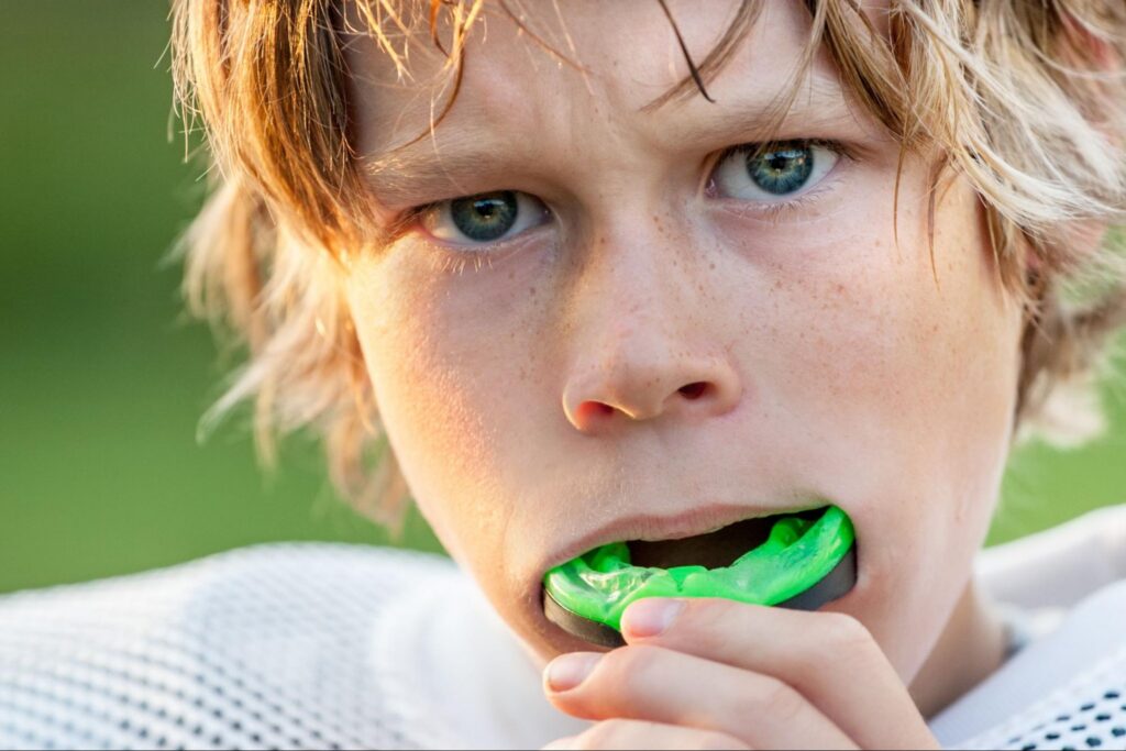 Teen athlete wearing a mouth guard for braces