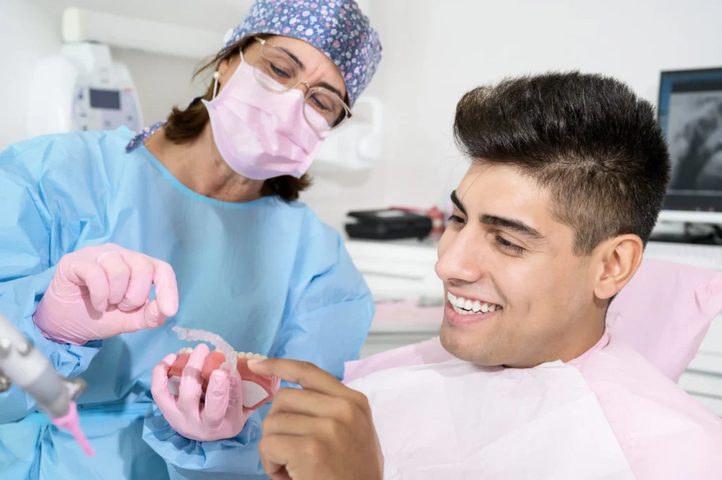 Orthodontist showing patient how to care for his aligners