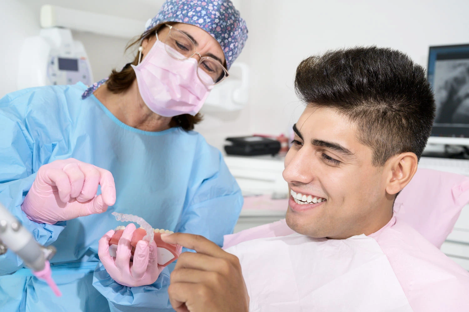 Orthodontist showing patient how to care for his aligners